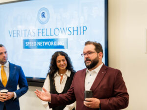 Image of Adam Radman speaking to a group of Veritas Fellows at CPI event
